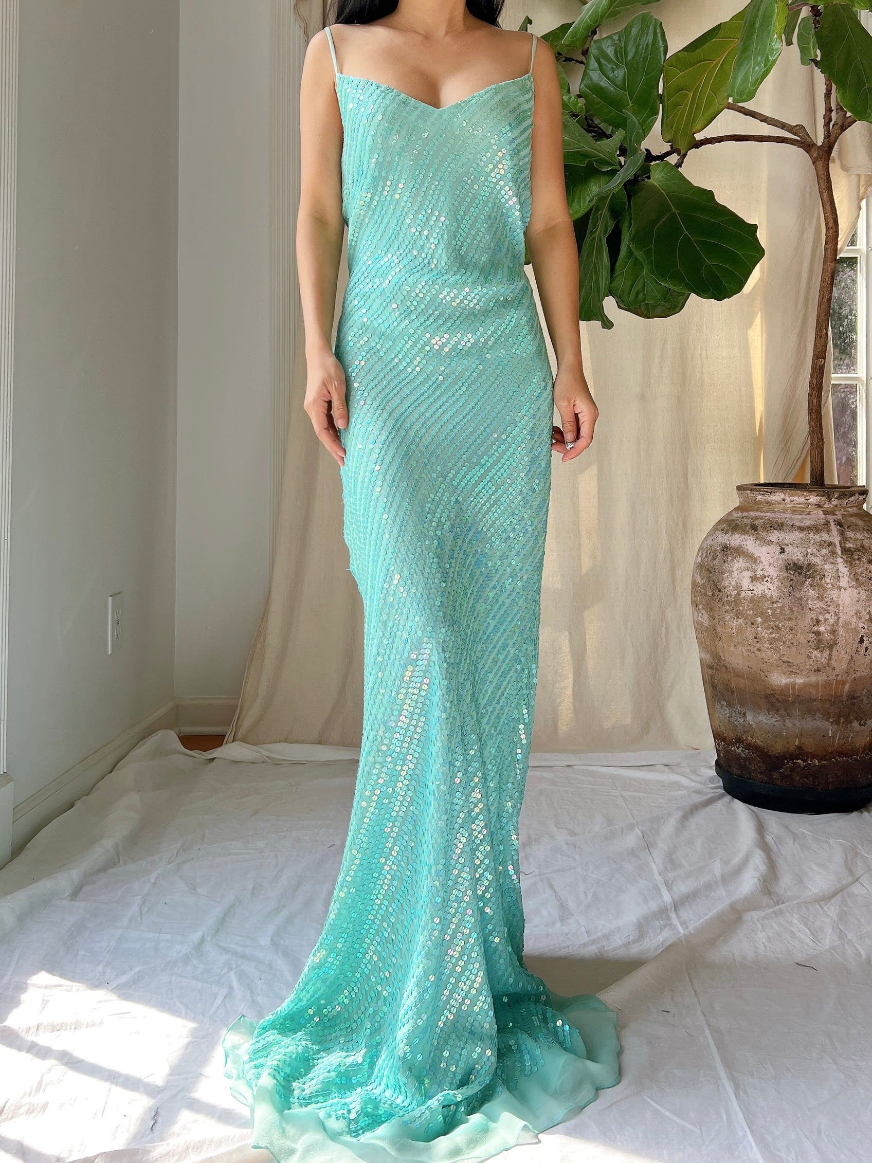 bias cut silk sequin dress SS'26 Bias-cut slip dress in ivory sequins with a draped cowl neckline and fine straps. Tailored darts sculpt and define the body, while the liquid sequin surface catches the light, shaping a
